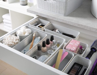Bin in a open drawer filled with items
