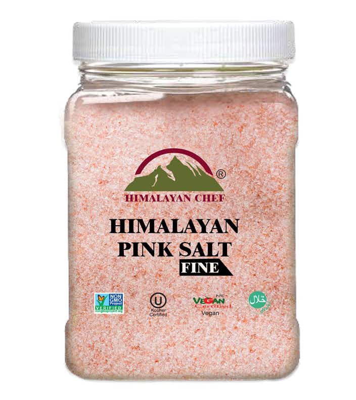 A jar of pink himalayan salt on white background