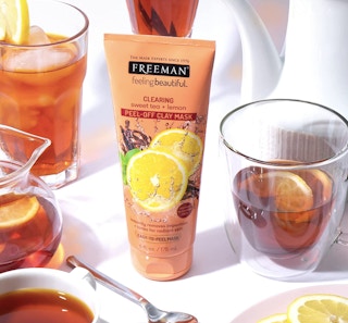 bottle of freeman feeling beautiful facial mask tube on a table surrounded by glasses of iced tea with lemons