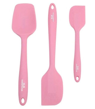 Three pink spatulas on a white background