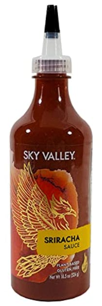 A stock image of a bottle of Sky Valley brand sriracha hot sauce.