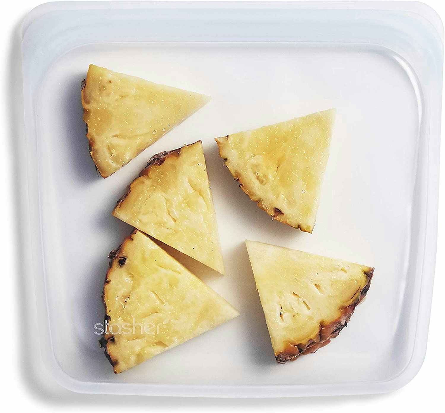 A clear Stasher bag with pineapples inside.