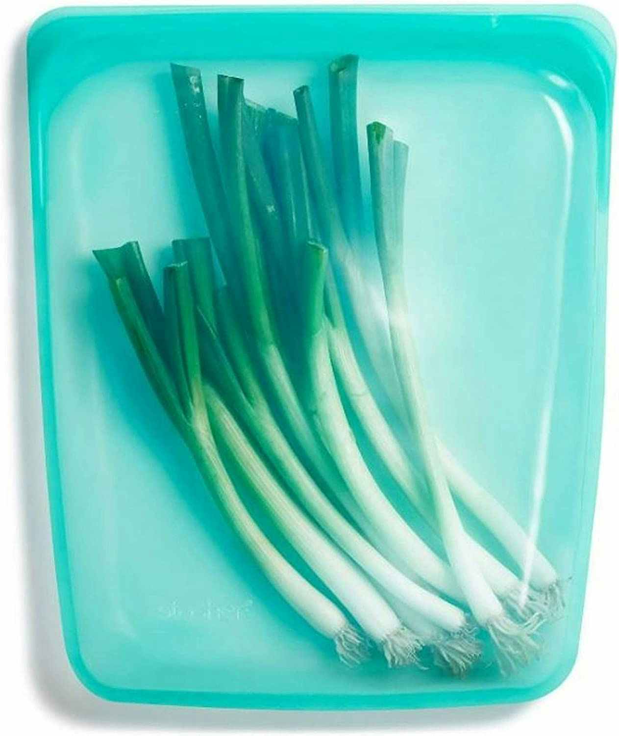 A Stasher bag in the color aqua with food inside.