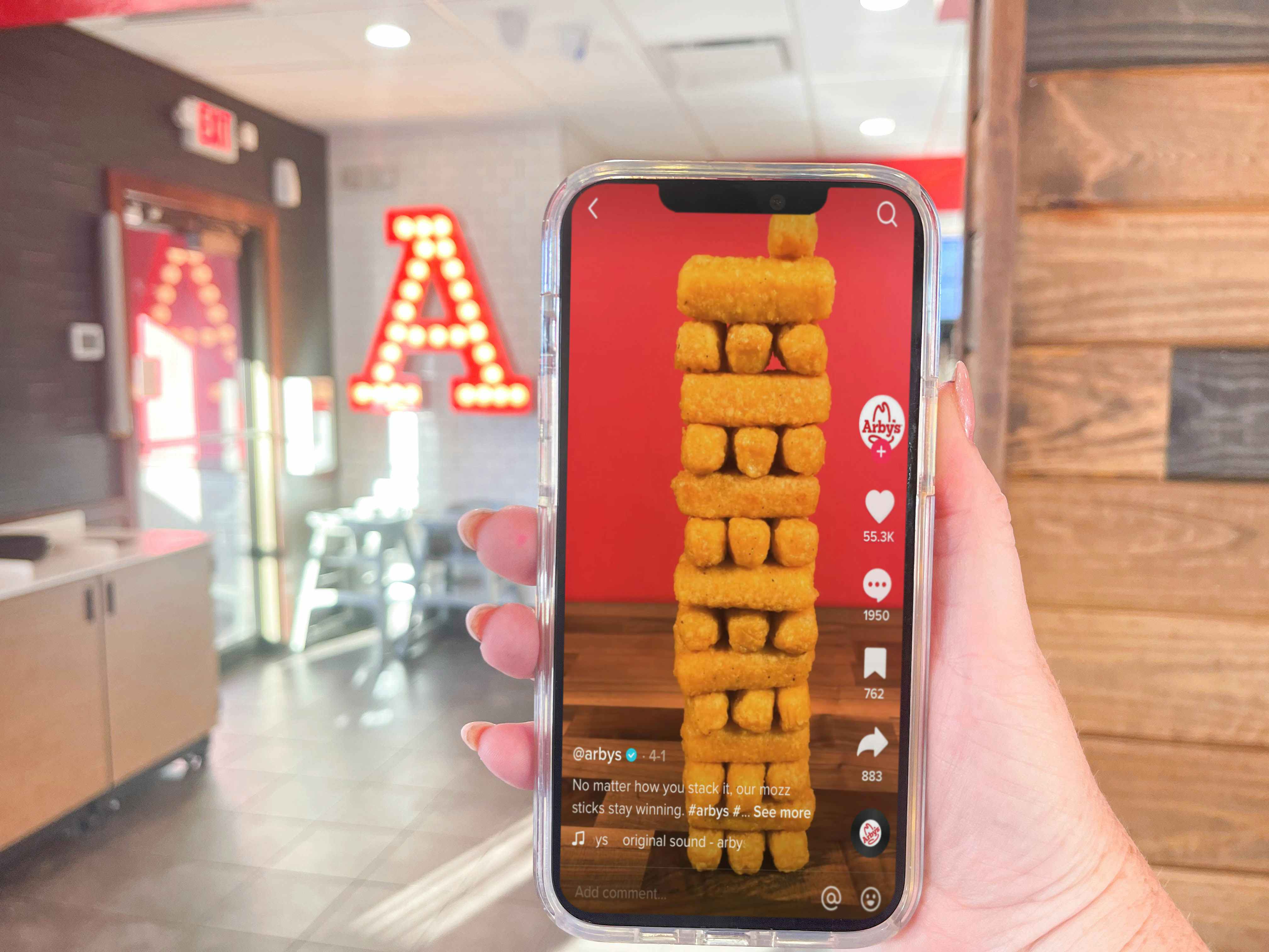 a person on a cellphone with arbys instagram in arbys 