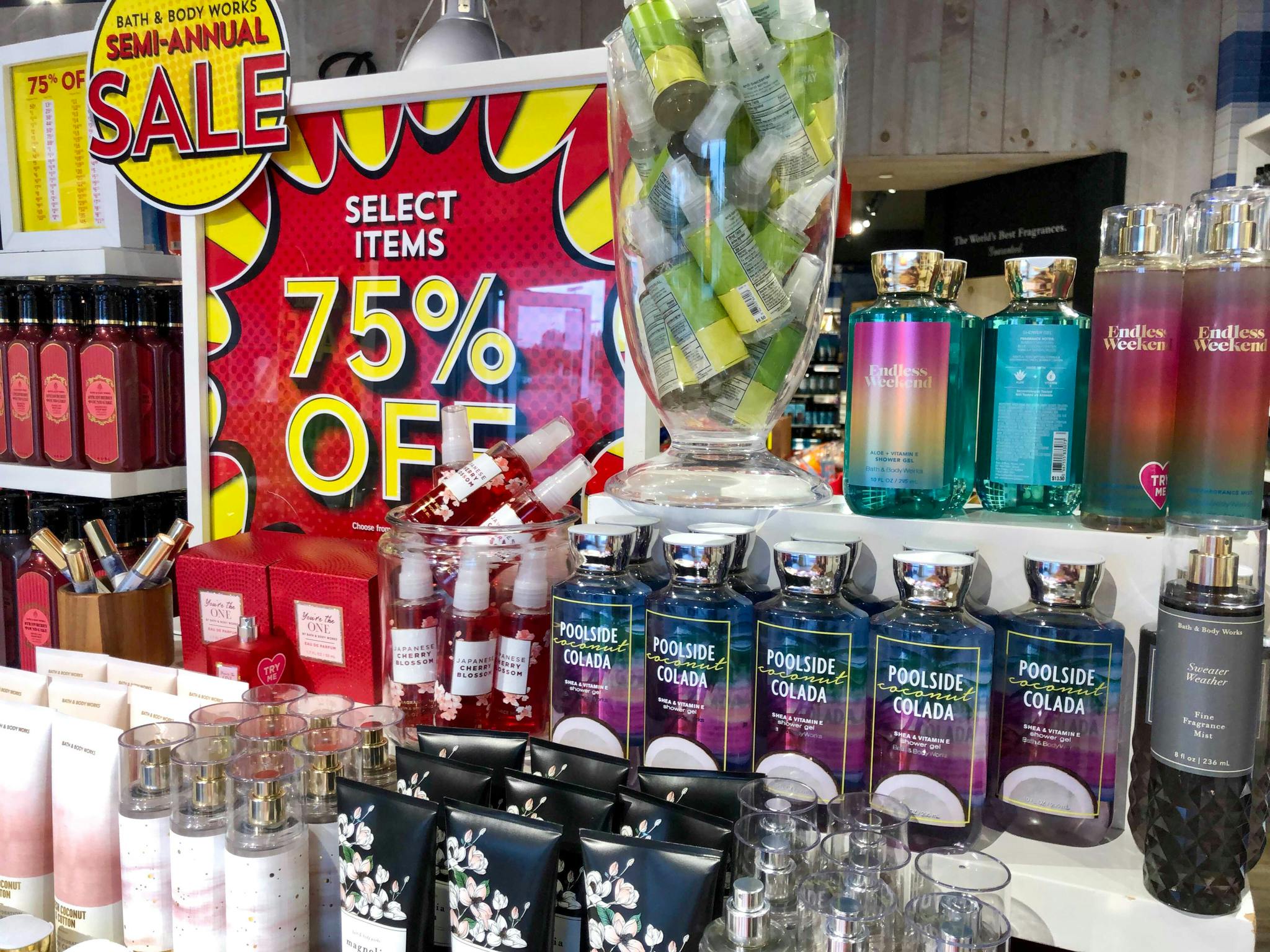A display for the Bath & Body Works Semi-Annual Sale with a 75% off sign and body care products
