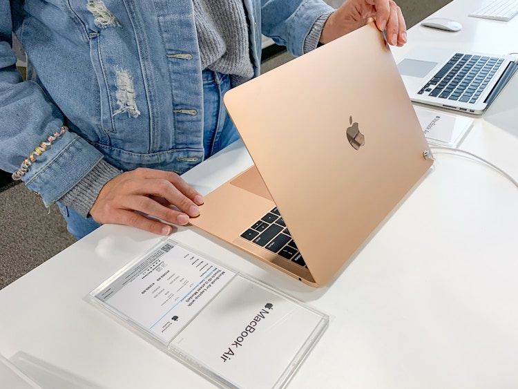 Someone looking at a Macbook Air at Best Buy