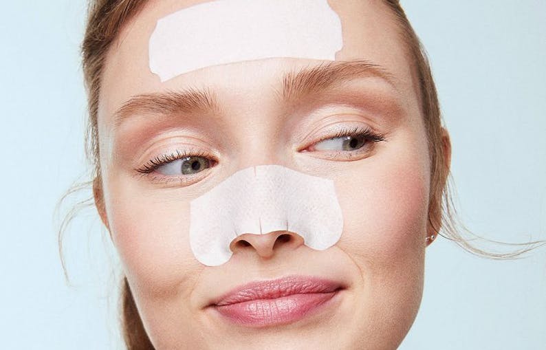 woman with biore pore strips on her forehead and nose