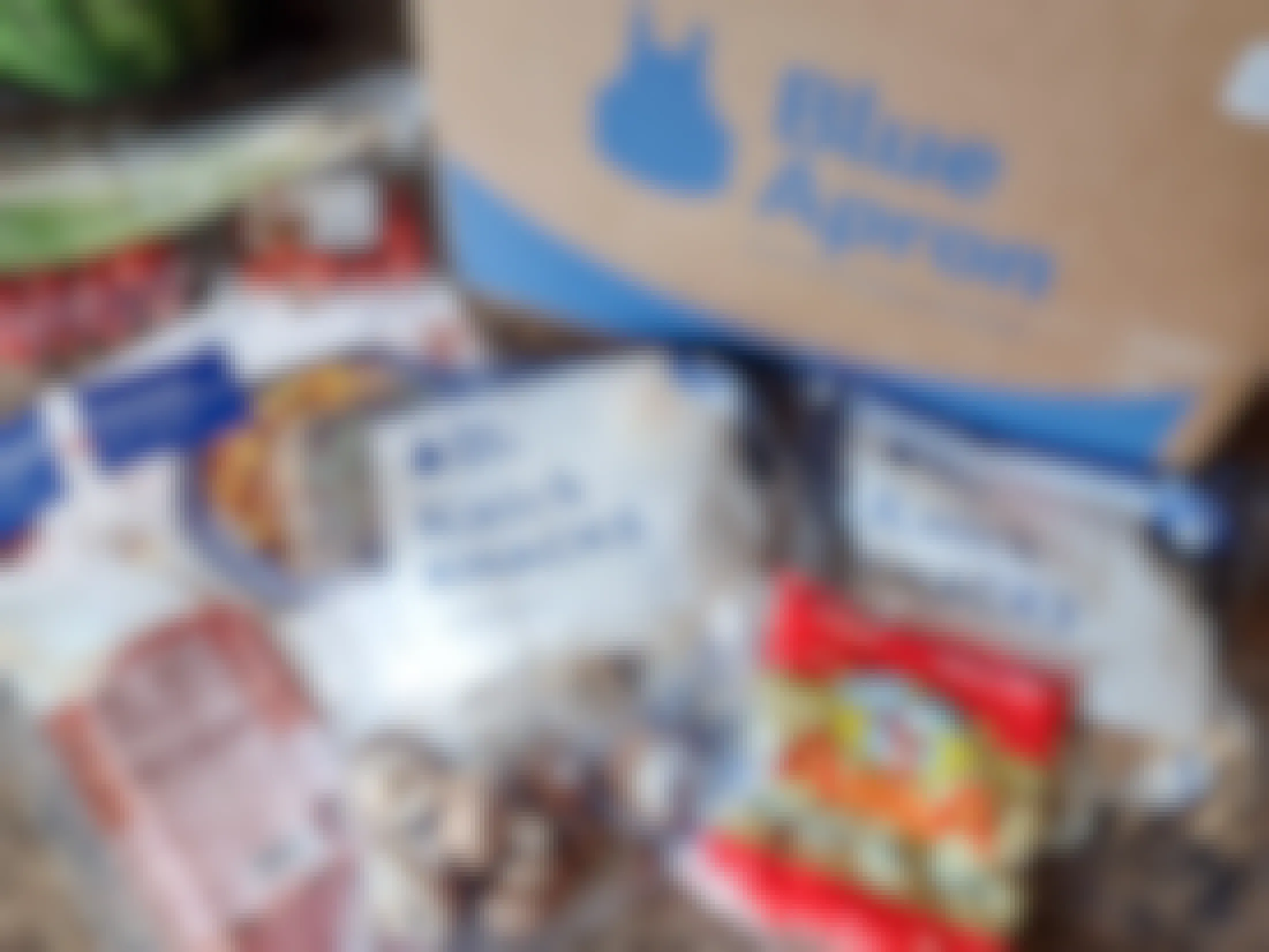 A Blue Apron box and its contents on a counter