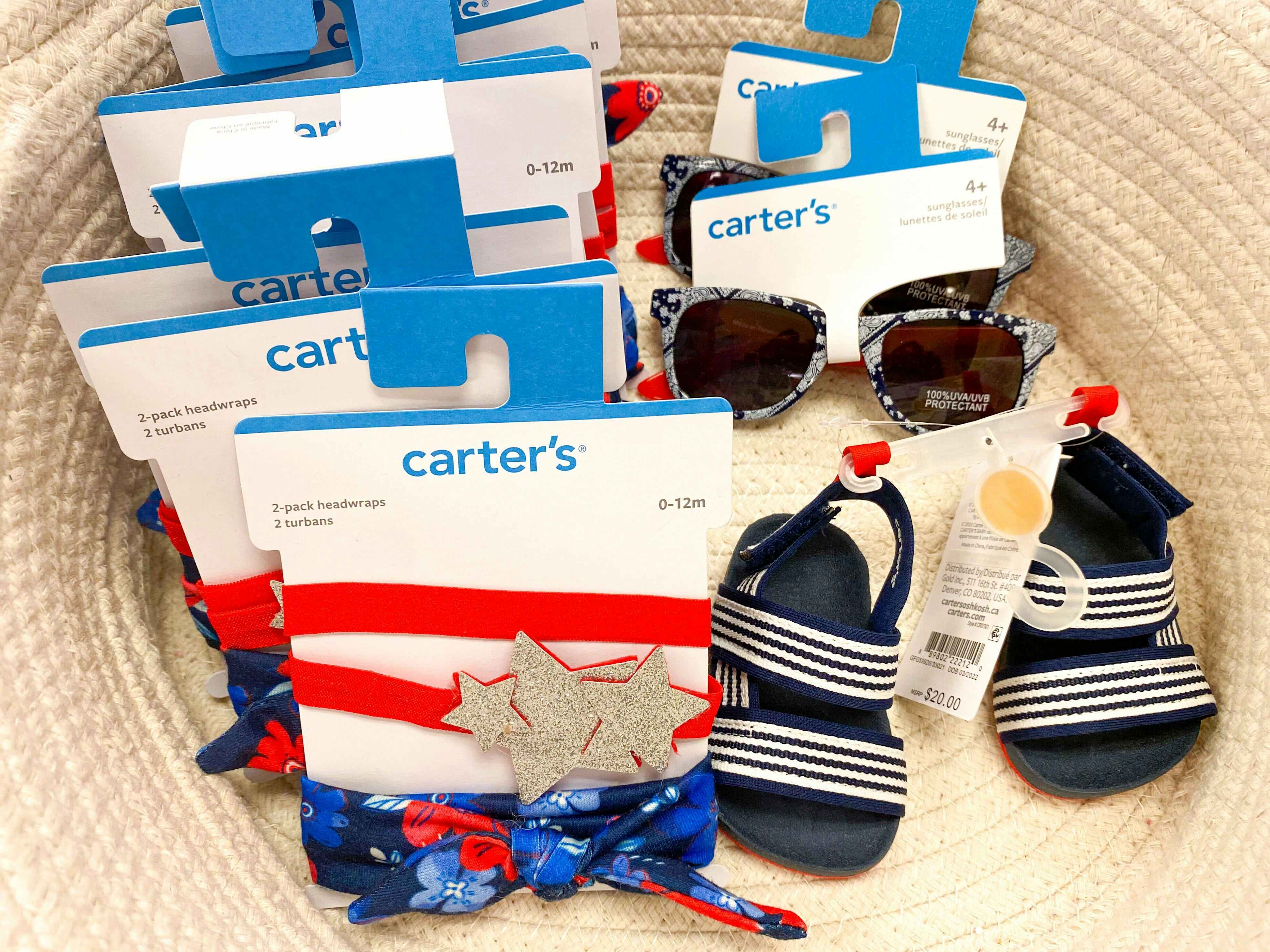 a basket full of fourth of july bows, sunglasses, and sandals