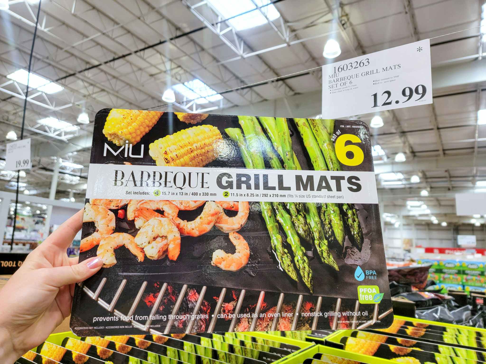 hand holding a set of 6 bbq grill mats