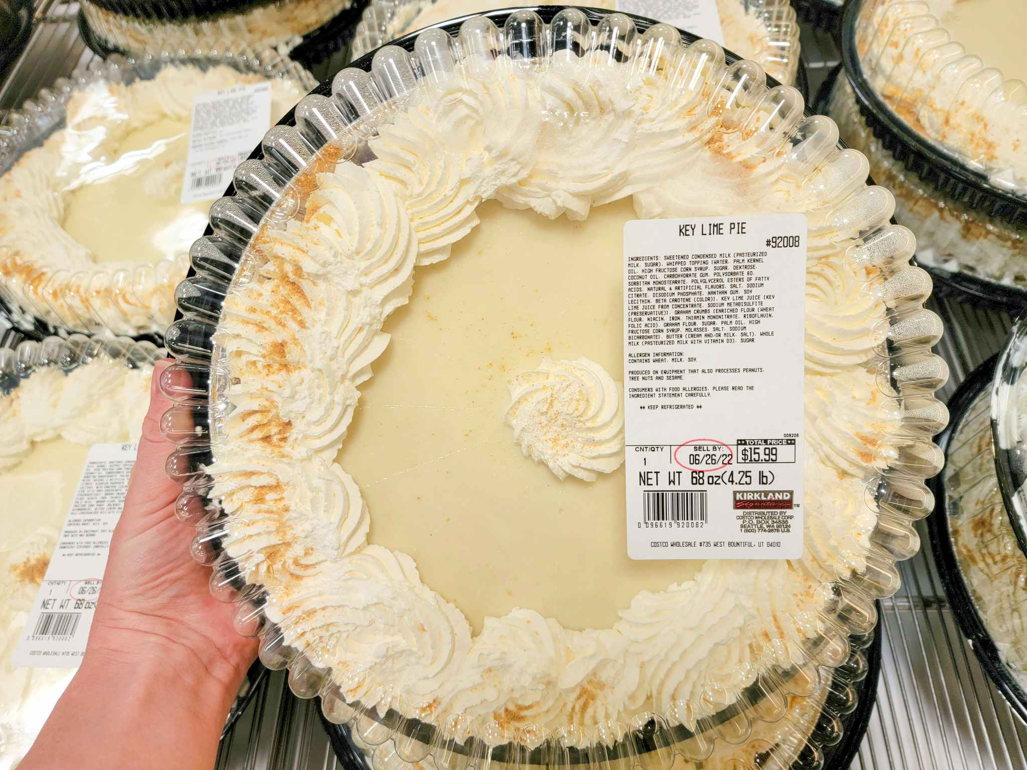 hand holding a large key lime pie