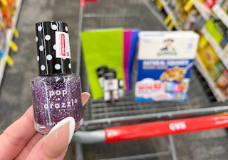 hand holding pop-arazzi nail polish in front of cvs cart