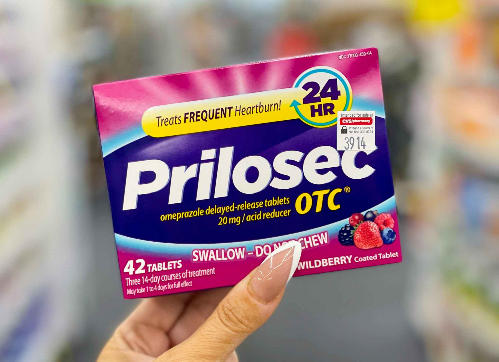 hand holding prilosec otc box