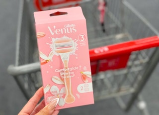 venus razor held in hand in front of cvs cart