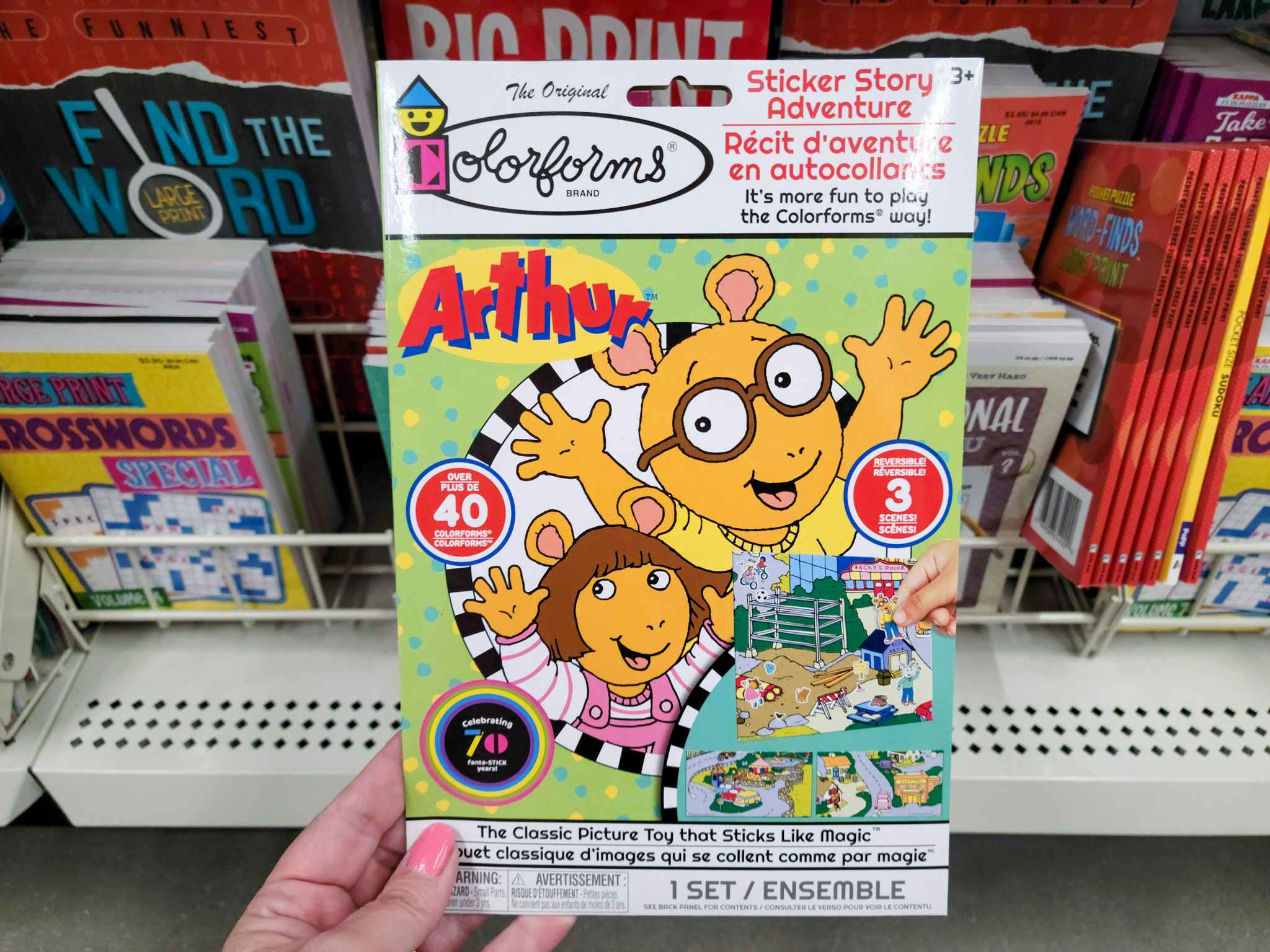 hand holding an arthur activity book