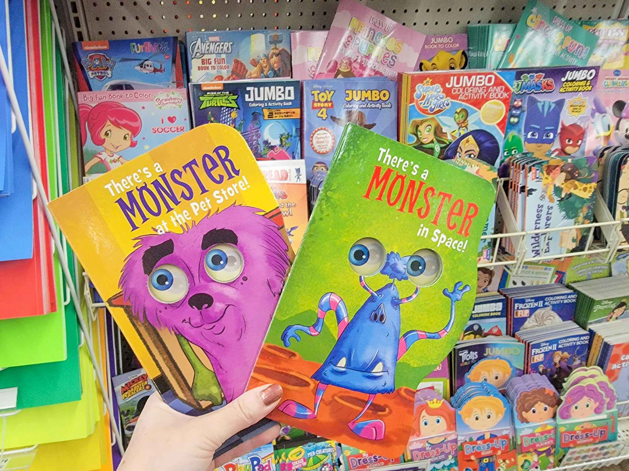 hand holding two monster kids books