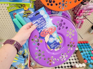 hand holding a purple bubble flying disc