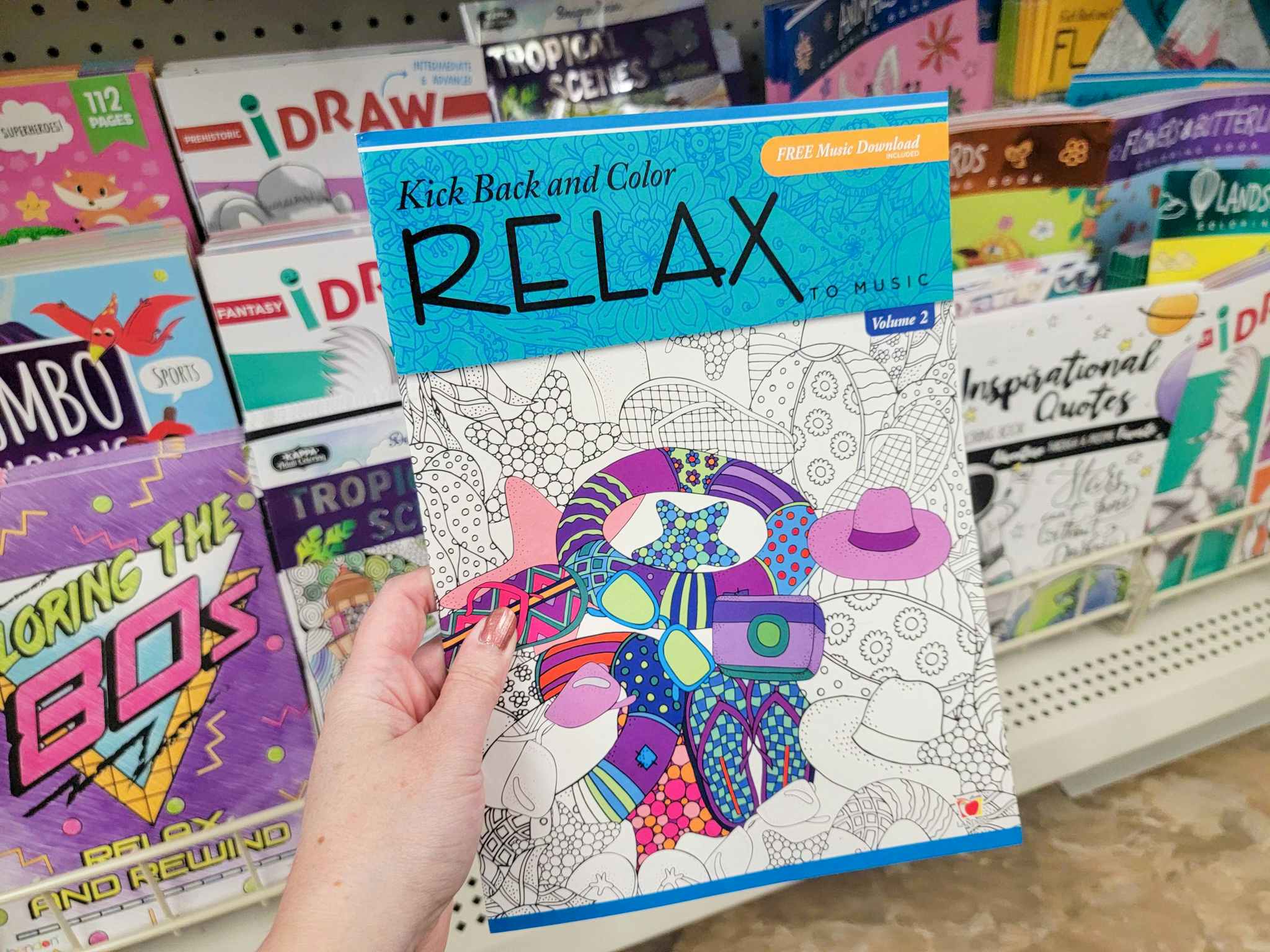 hand holding a relax to music adult coloring book