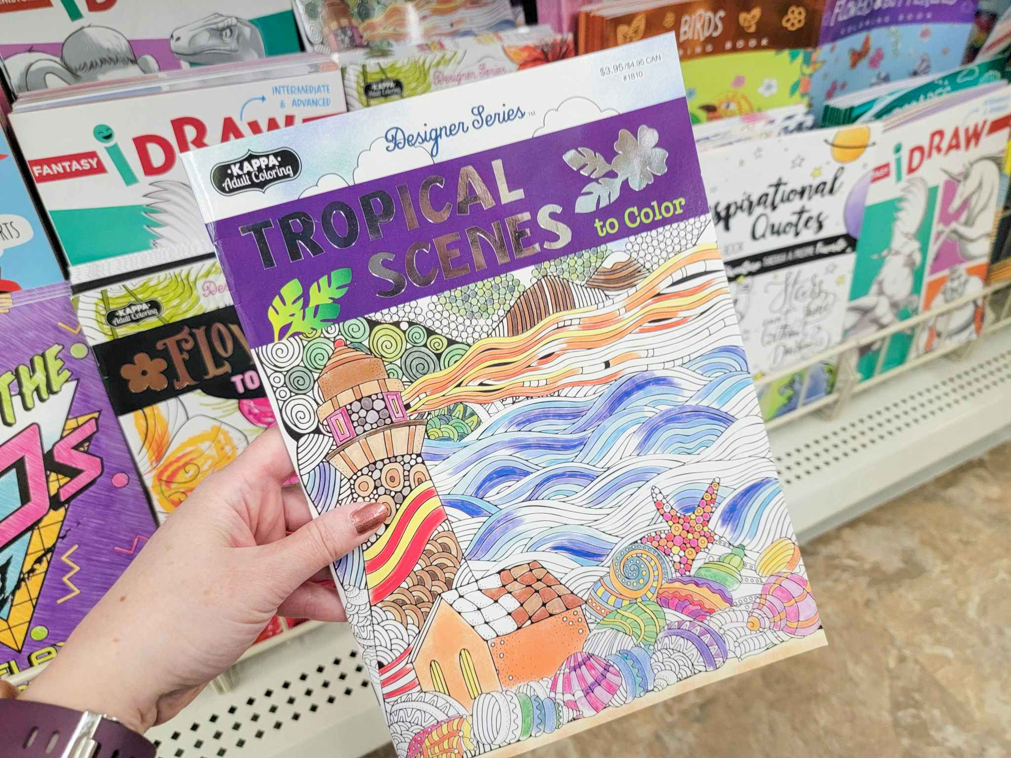 hand holding a tropical scenes coloring book