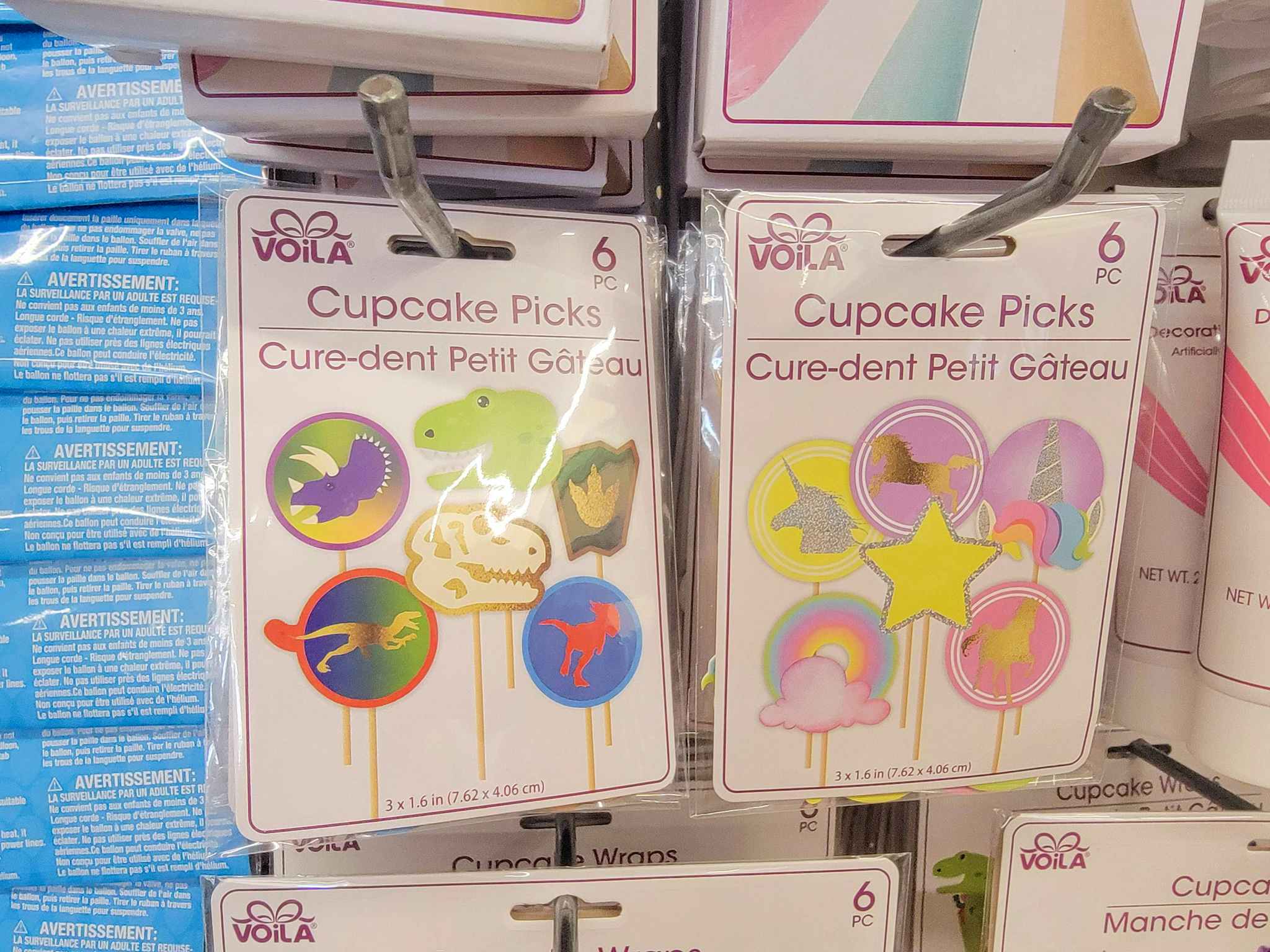 two designs of cupcake picks, dinosaurs and unicorns