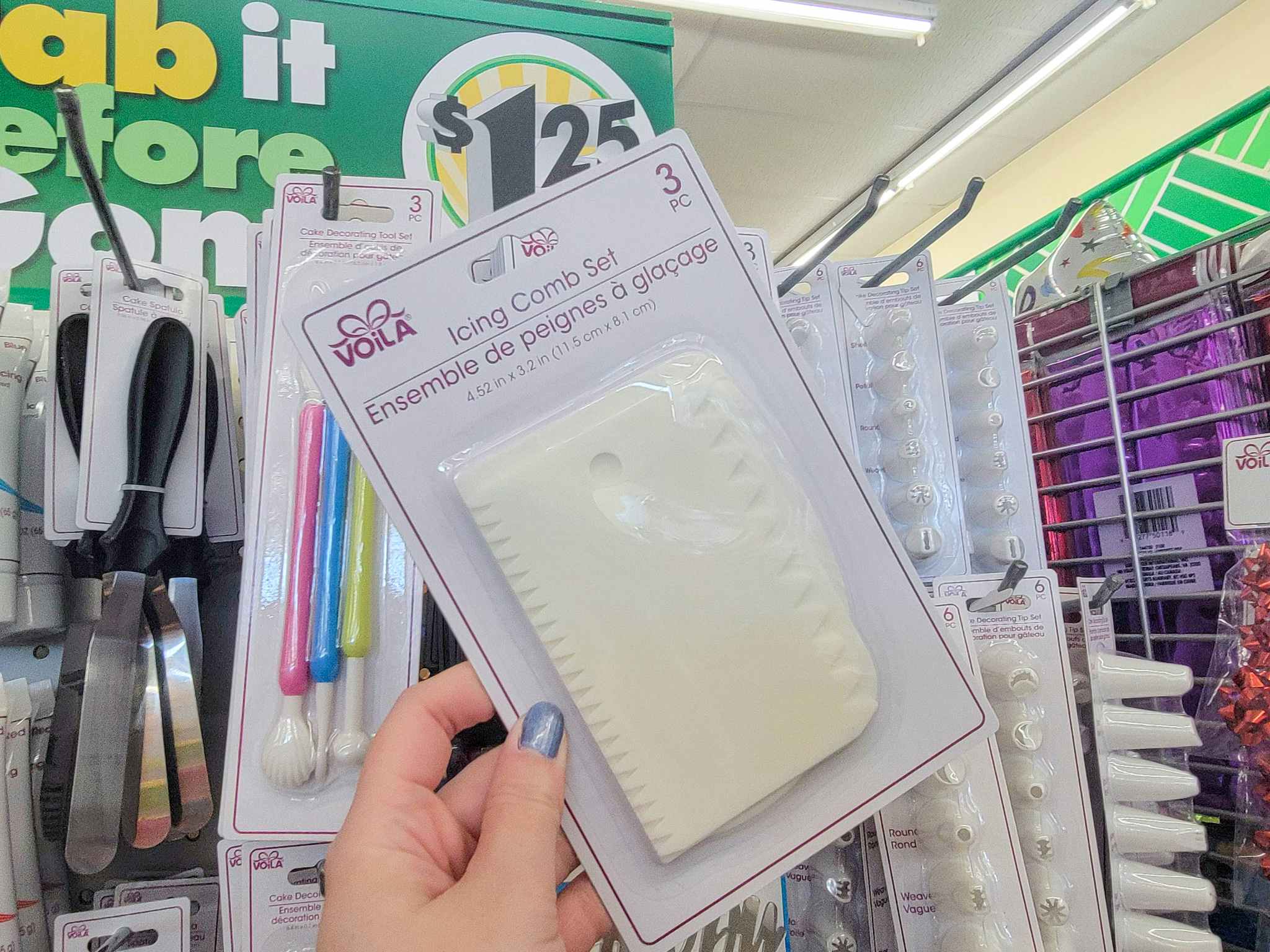 hand holding a pack of cake decorating icing combs