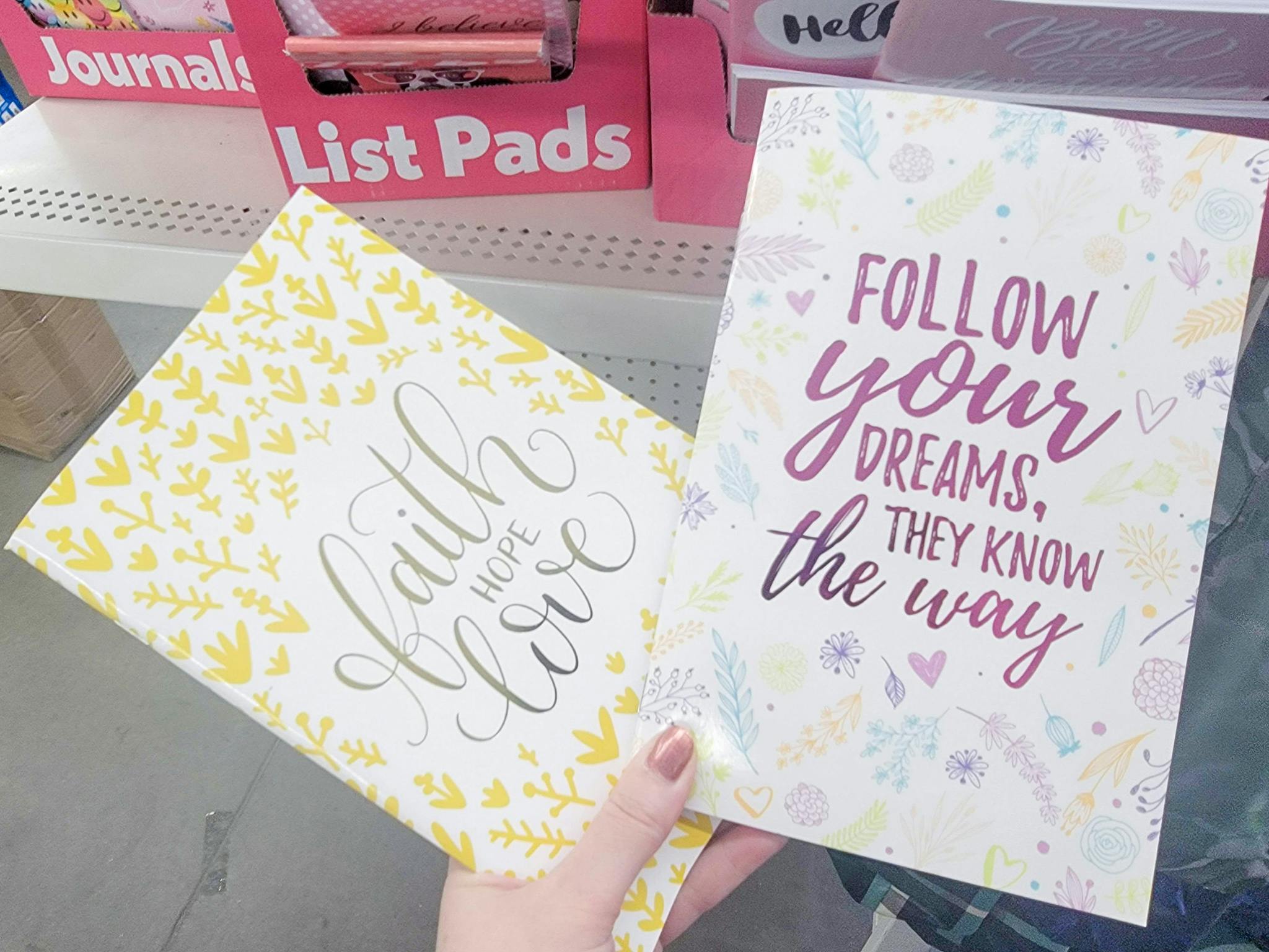 hand holding 2 journals