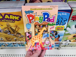 hand holding a play pad activity book