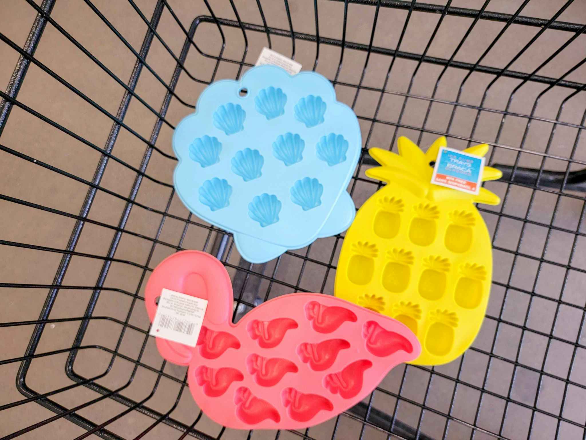 flamingo, pineapple, and shell shaped ice cube trays in a cart