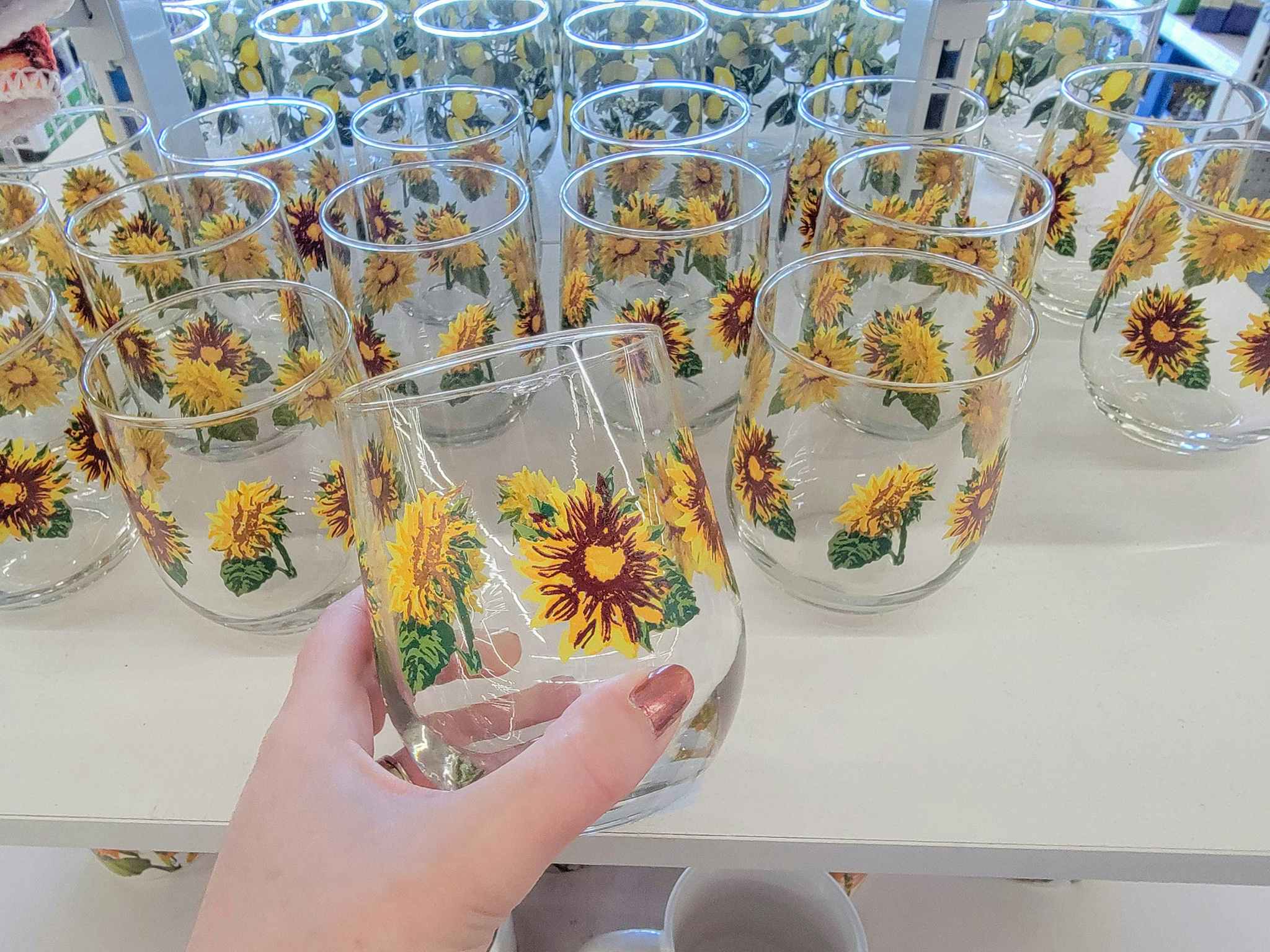 hand holding a sunflower glass