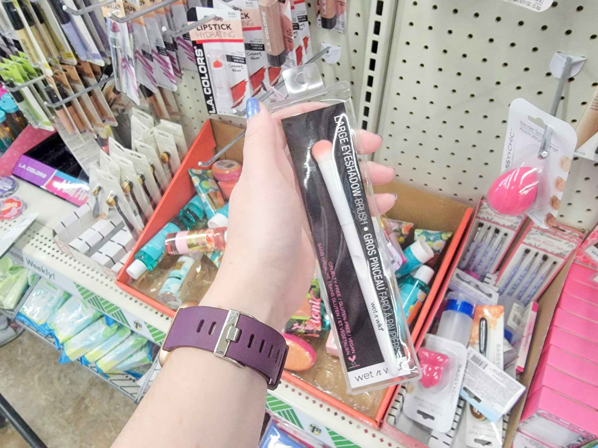 hand holding a wet n wild eyeshadow brush