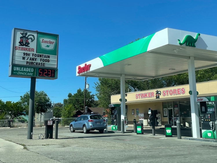 The outside of a Sinclair gas station with the unleaded price shown to be $5.23