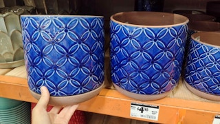 hand holding southern patio blue ceramic planter at home depot