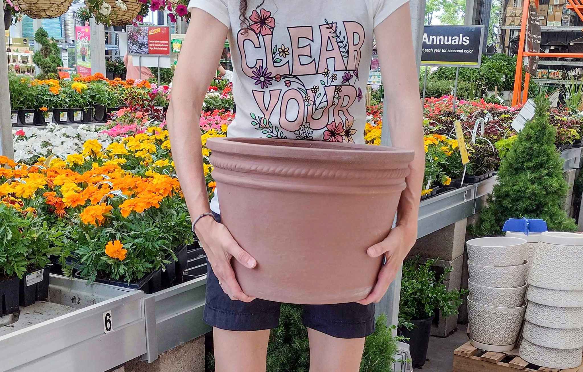 hands holding southern patio terra cotta planter at home depot