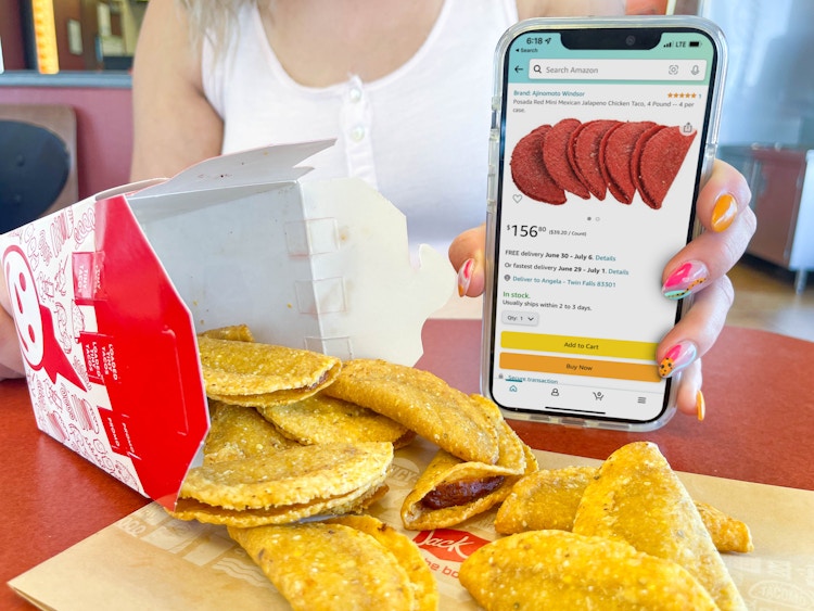 a woman holding a cellphone with amazon tacos on screen next too a box of mini taco spilling out