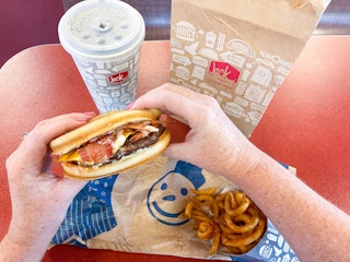 a person holding a sourdough jack with a combo on the table