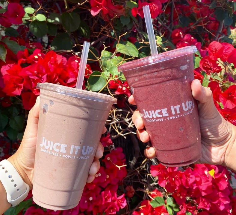 Two hands holding Juice It Up Smoothies