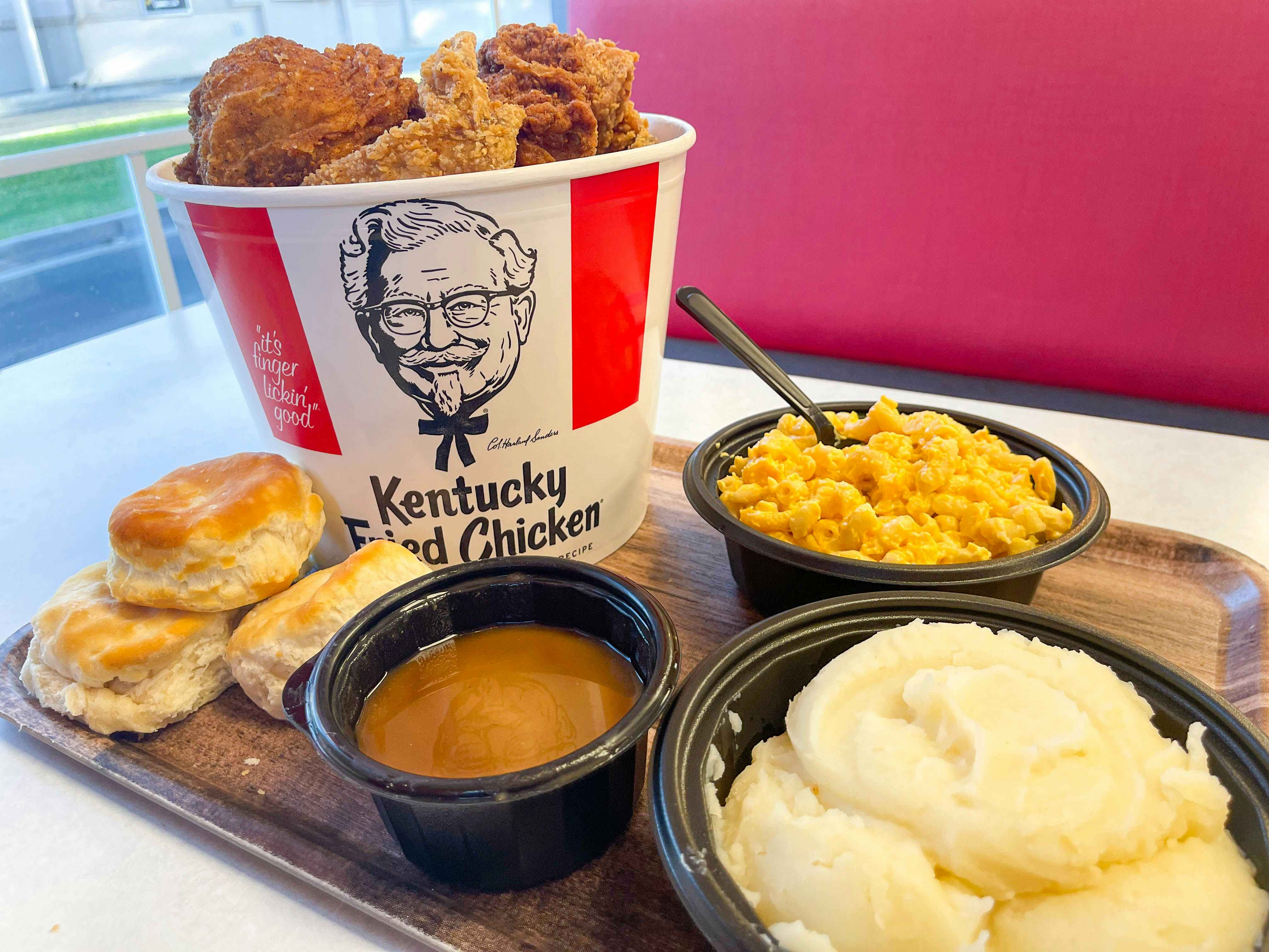 kfc bucket of chicken and meal on table