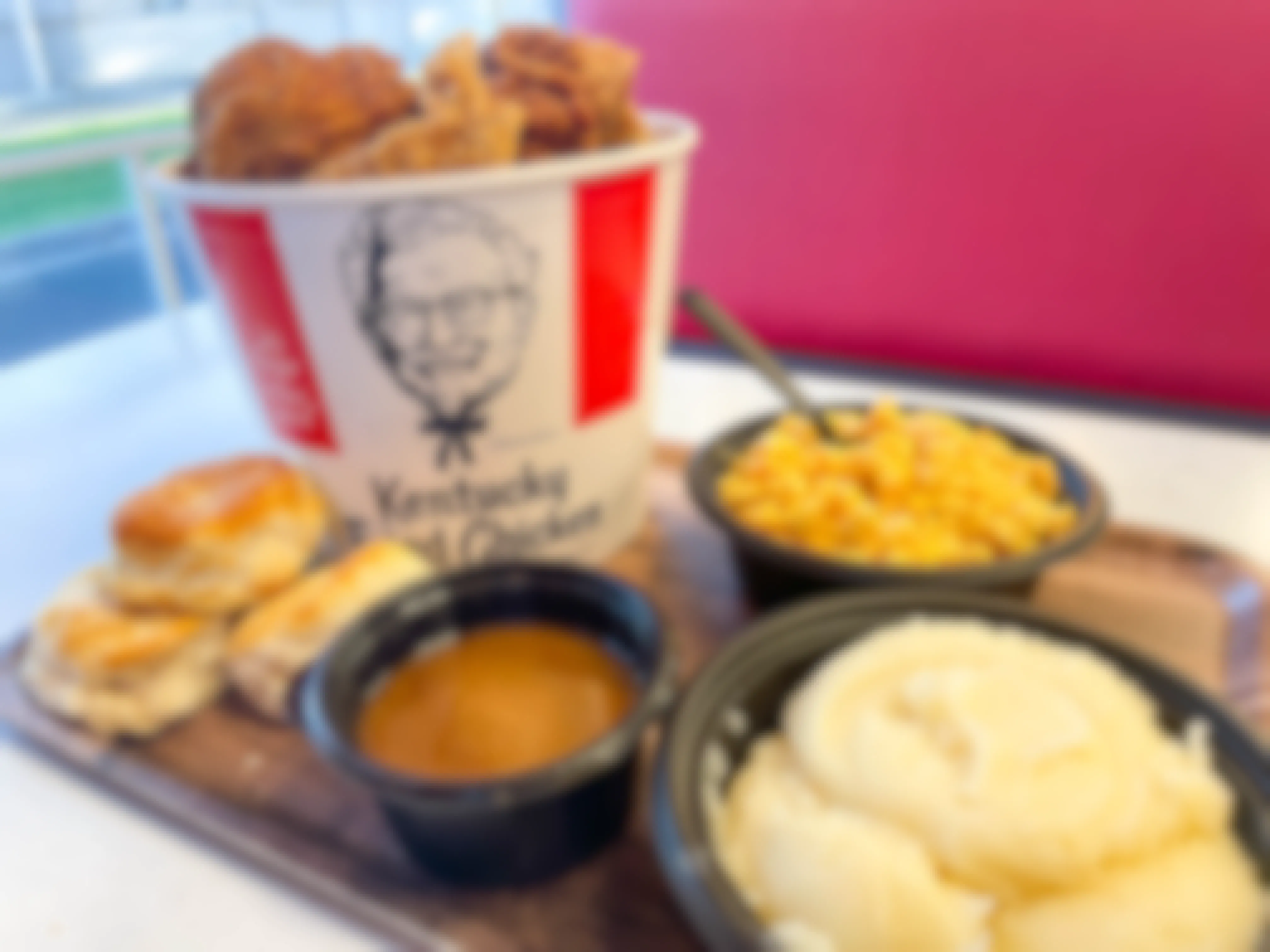 kfc bucket of chicken and meal on table
