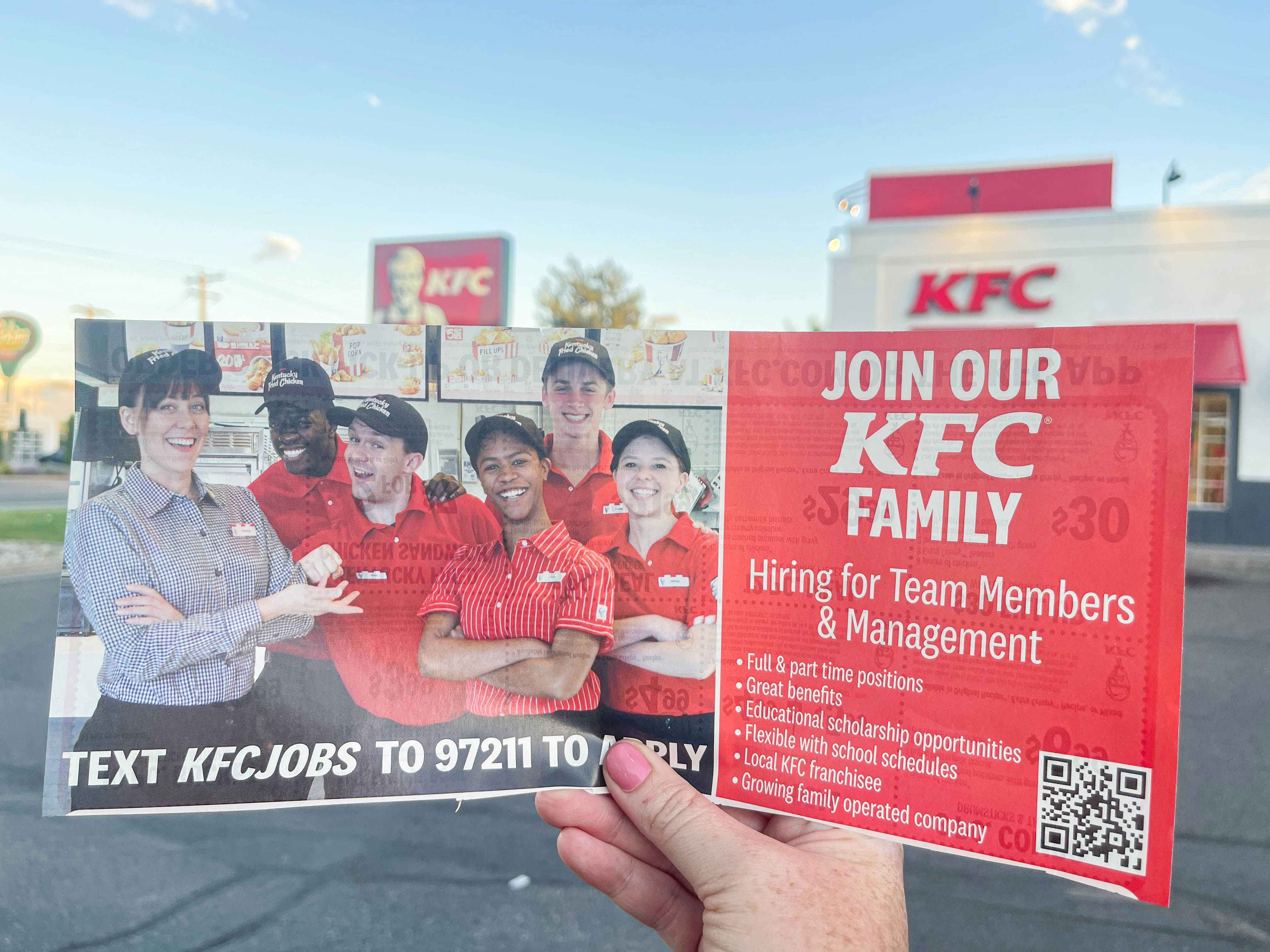 kfc hiring mailer ad being held up outside kfc