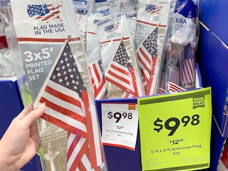 Valley Forge American Flags on display at Lowe's. Sales signs indicate that the price is $9.98, regularly $12.98.