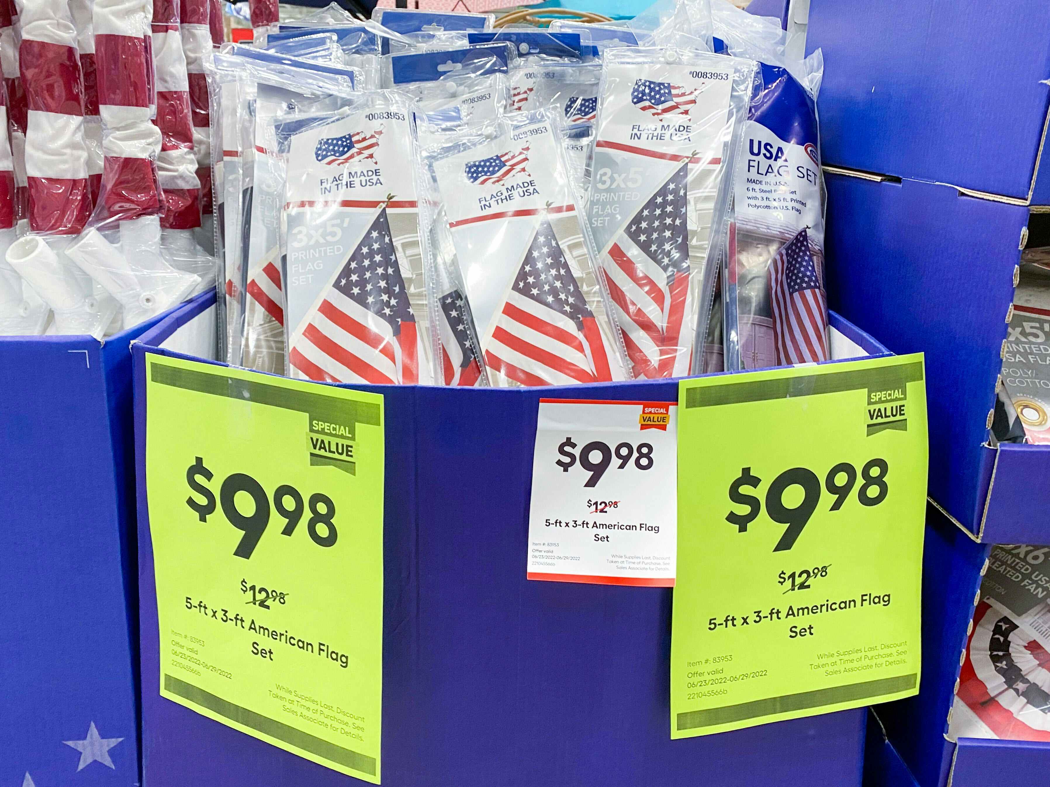 Valley Forge American Flags on display at Lowe's. Sales signs indicate that the price is $9.98, regularly $12.98.