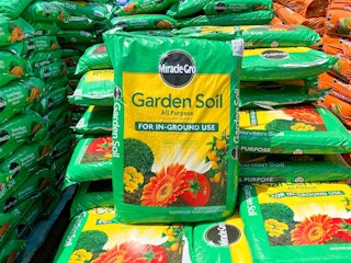 stacked bags of Miracle Grow soil at Lowe's