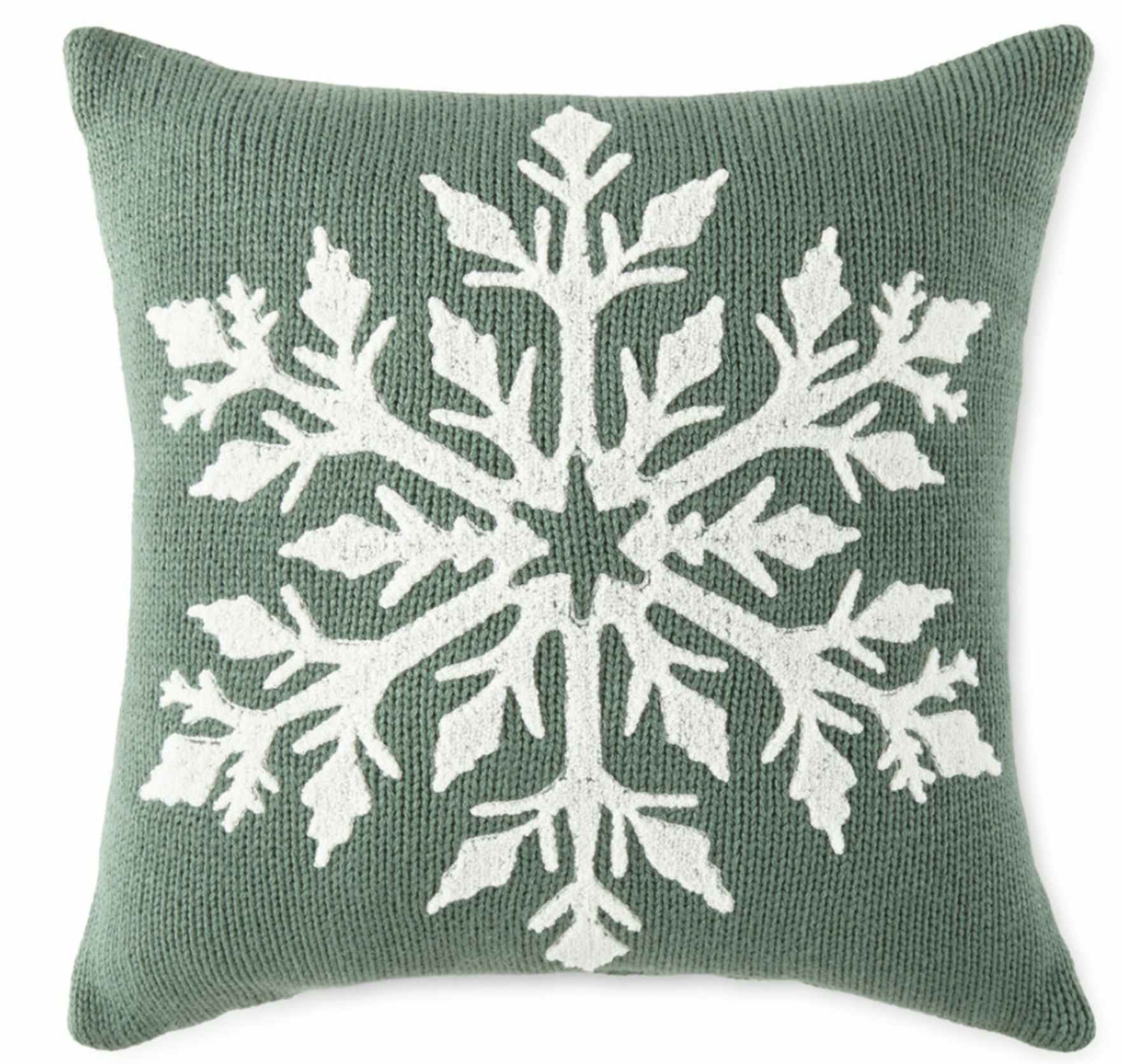 a sage green throw pillow with a white snowflake