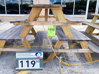 wooden patio table on sale outside at Lowe's