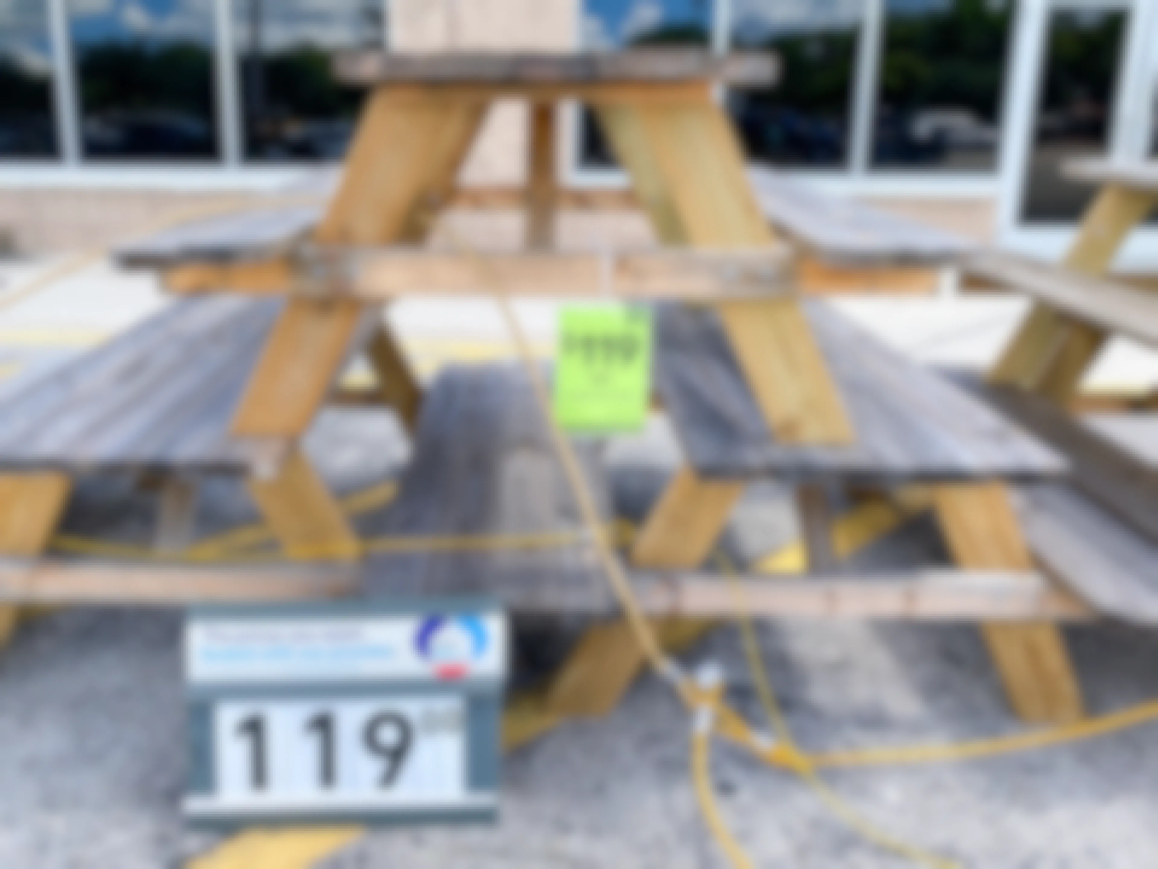 wooden patio table on sale outside at Lowe's