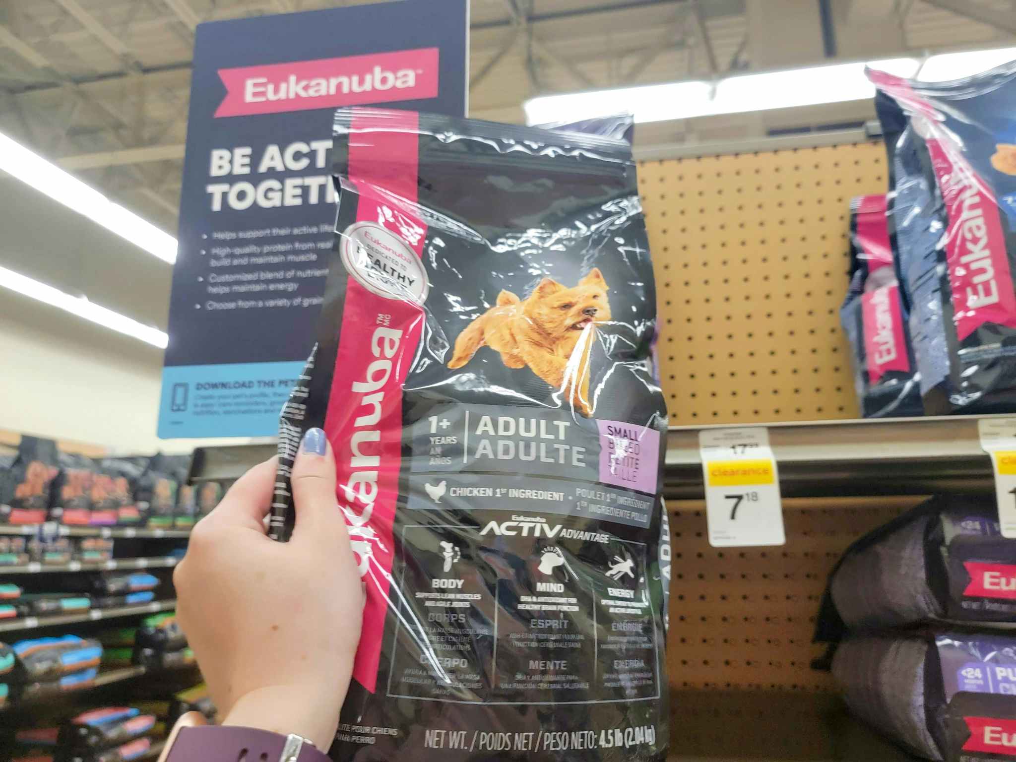 hand holding a small bag of eukanuba dog food