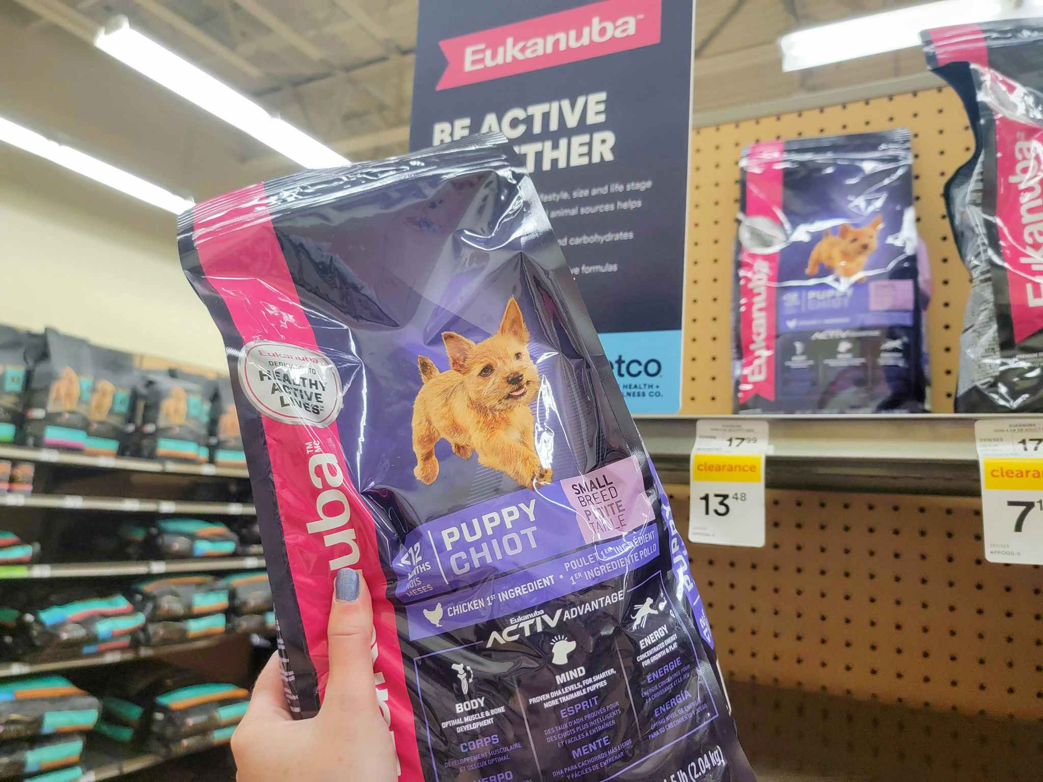 hand holding a bag of eukanuba puppy food