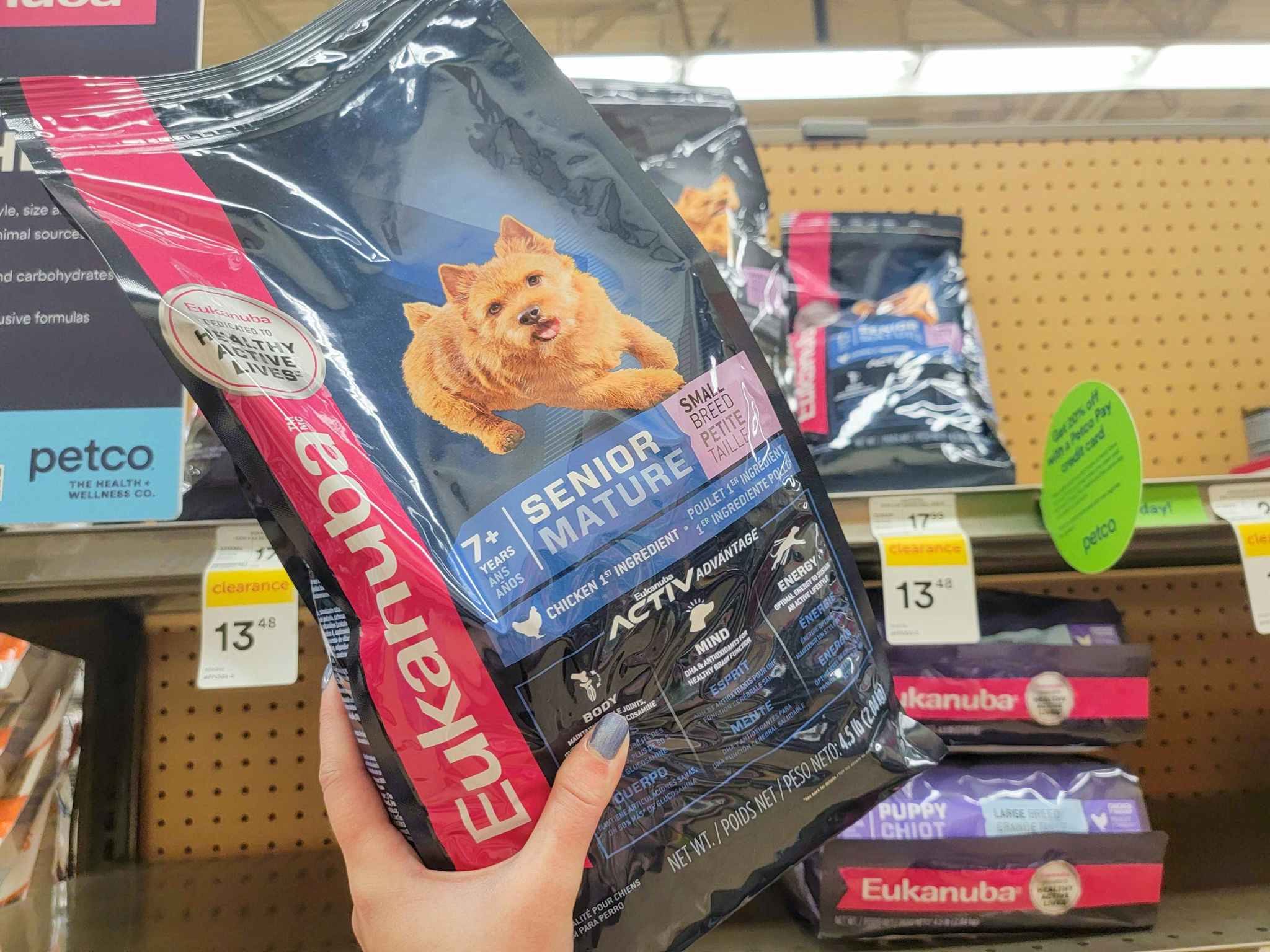 hand holding a bag of eukanuba senior dog food