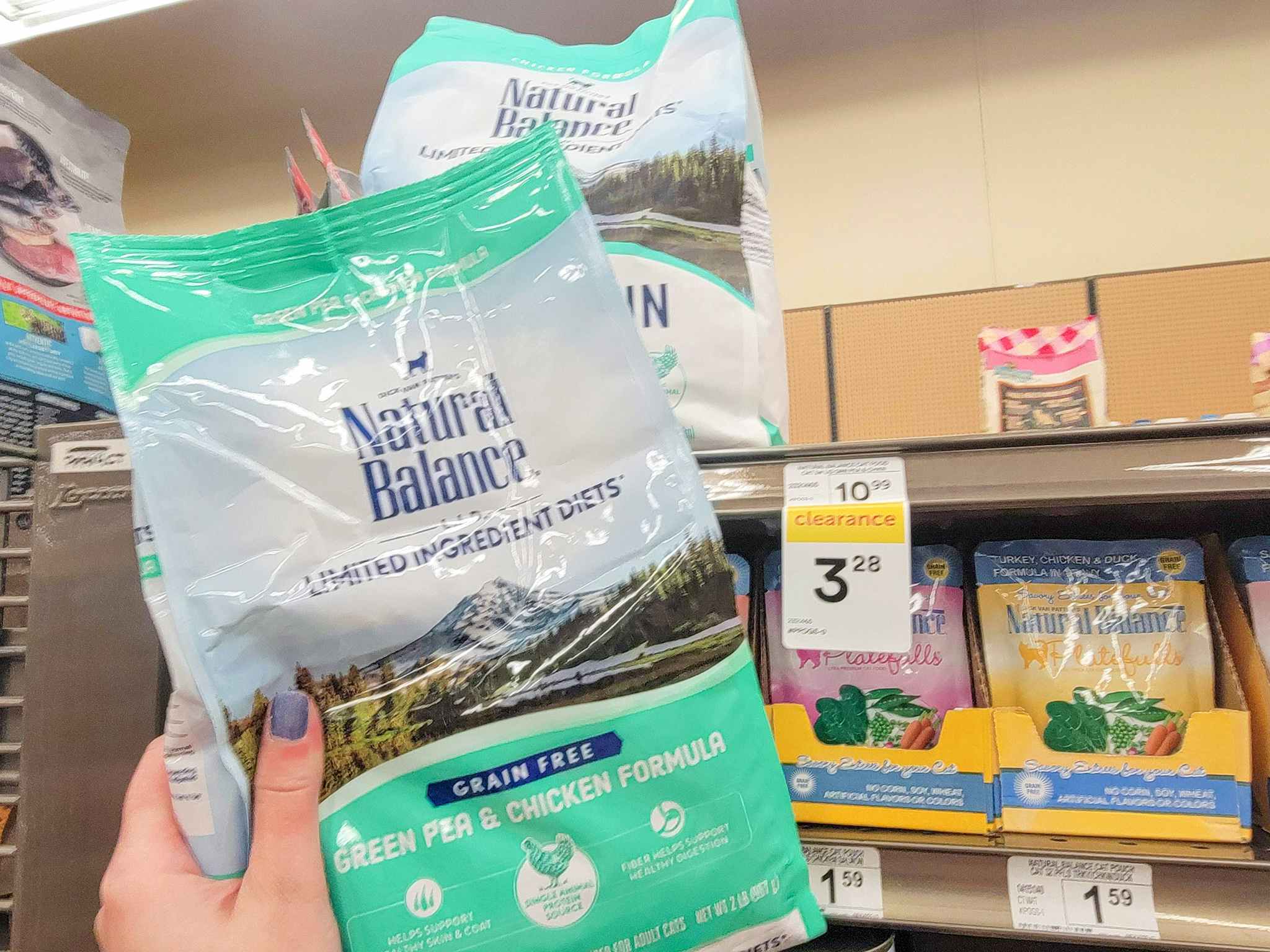 hand holding a bag of natural balance cat food