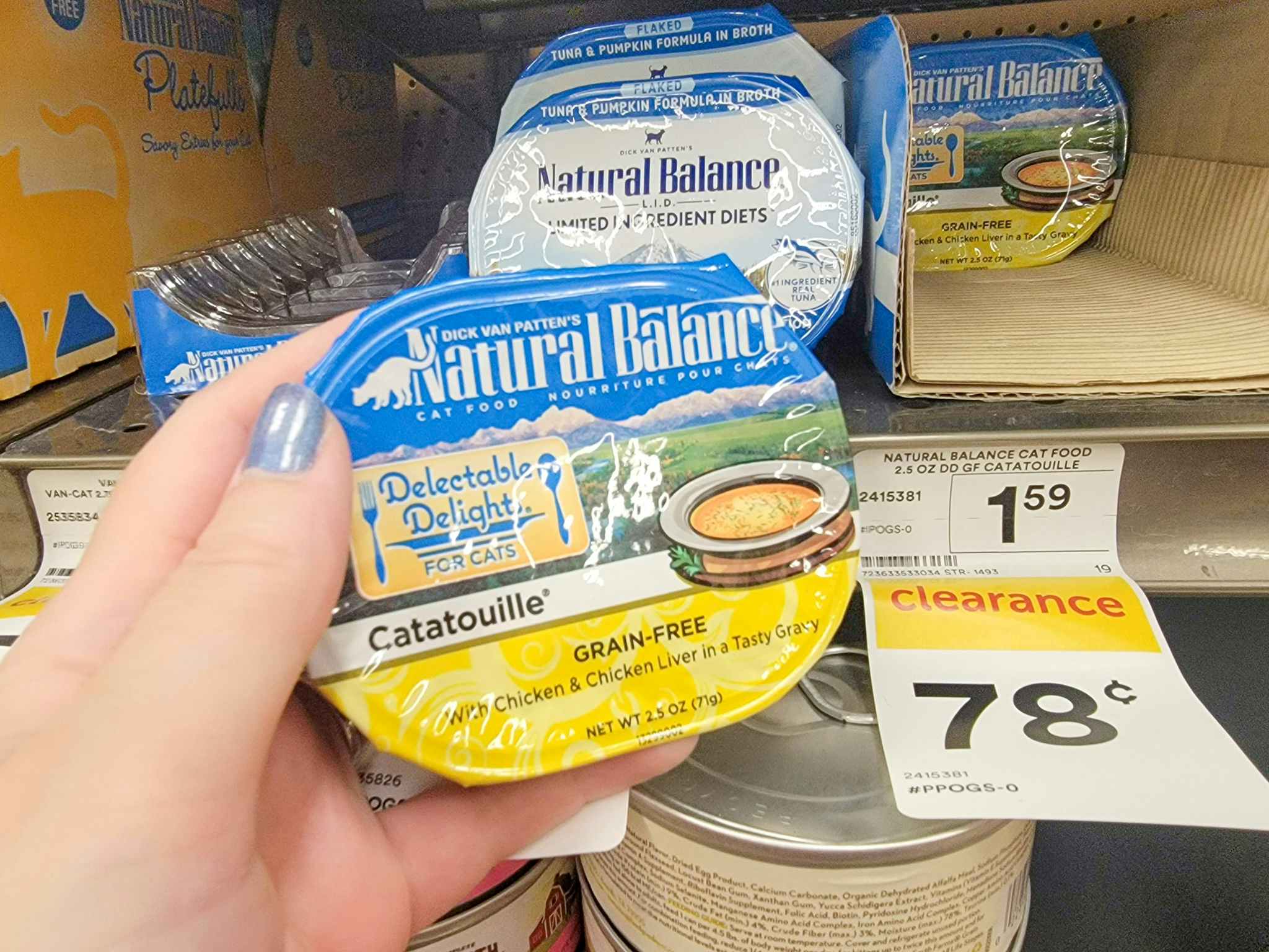 hand holding a container of natural balance cat food